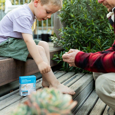 Aero Junior Plasters Putting plaster on child's leg 